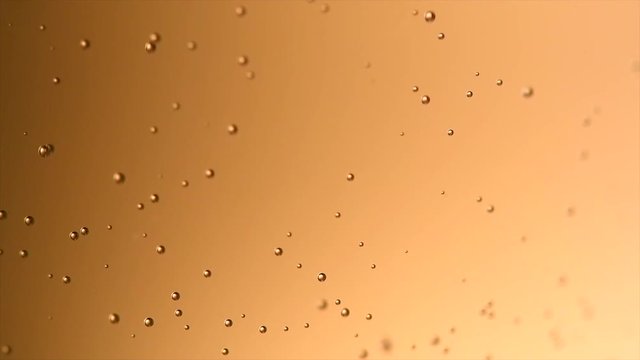 Champagne bubbles background closeup. Macro shot of sparkling wine gold backdrop. Bubbly fizzing champagne closeup. Slow motion 4K UHD video footage. 3840X2160