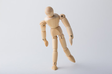 Wooden dummy standing on one leg 