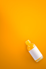 Top view of the water medicine bottle is on a yellow background.