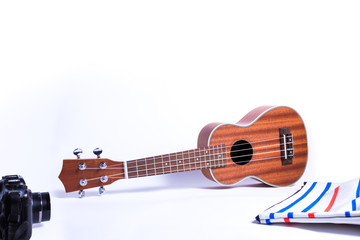 ukulele and camera, bag., Musician accessories isolated on white background.