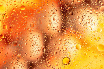 water drops on glass with orange and pink background, close-up 