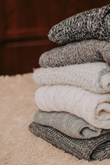 knitted sweaters on a soft peach carpet close-up