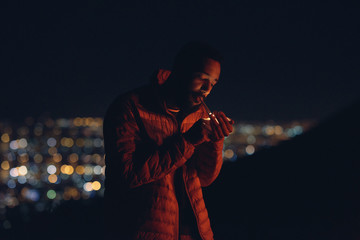 Cinematic shot of man lighting a cigarette