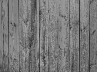 Old dark black and white vintage rustic aged antique wooden panel with vertical gaps, planks and chinks background texture