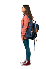 A full-length shot of a Teenager girl with sweatshirt and backpack in lateral position
