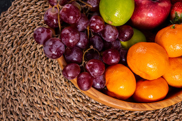 Healthy food: mix from fruits in bowl, old wooden background, selective focus