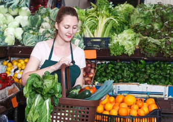 Seller is holding vegetables in basket