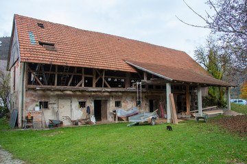 Fototapeta na wymiar old big barn from side slowly being demolished