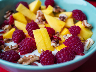 Delicious fruit bowl with red background