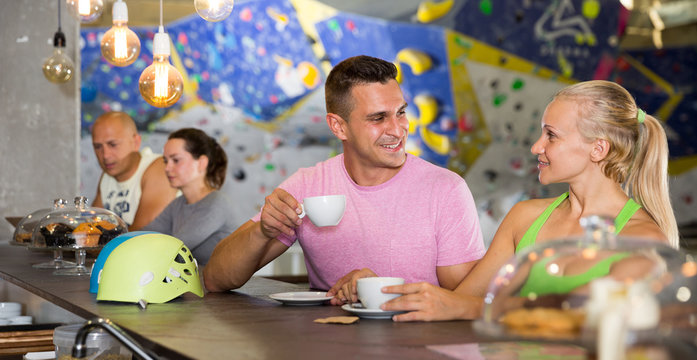 Couple drinking coffee at bouldering gym