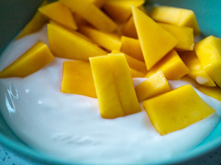 Delicious fruit bowl with mango and yogurt
