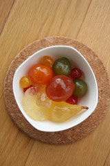 Traditional italian Mostarda with candied fruits in a bowl on wooden table. Italian musturd 
