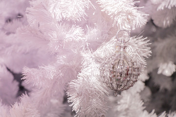 Decorated gift on  white Christmas tree closeup.ball and gift Christmas eve seasonal.