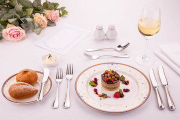 Giving of a tortina from a liver of a guinea fowl, moves with lemon brioshy, wild berries and a glass of white wine