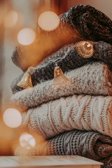 A bunch of sweaters, light bulbs, lanterns, cozy winter interior details, home decor and comfort.