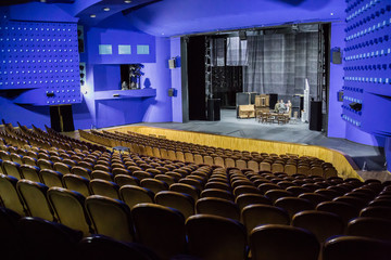 Empty auditorium and stage in the theater. Rehearsal of the play. Artists on stage. © Andrey Lapshin