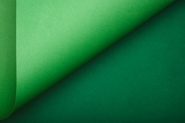 top view of green paper on colored background