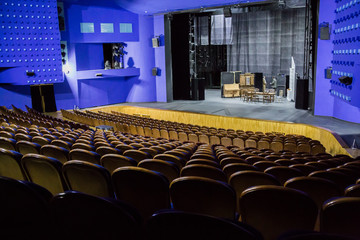 Empty auditorium and stage in the theater. Rehearsal of the play. Artists on stage.