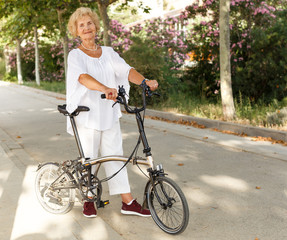 Elderly woman going to biking