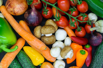 Background surface of various vegetables placed on black background