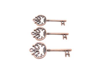 Vintage copper keys on white background close up