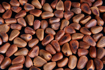pine nuts on a black background