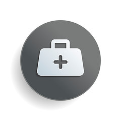 first-aid kit, simple icon. White paper symbol on gray round button or badge with shadow