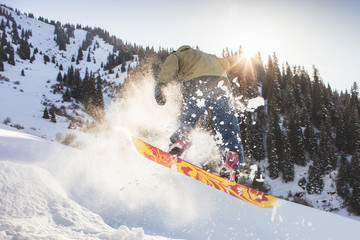 Snowboarder doing his trick one eighty