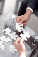 business partners put the pieces of the puzzle.