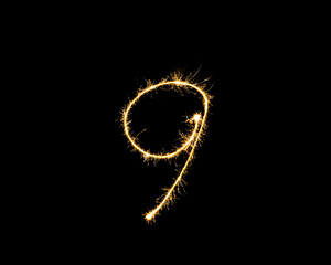 Numbers 9 or nine Sparkler firework light isolated on black background