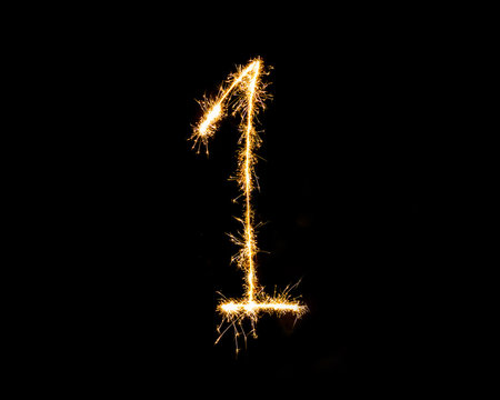 Numbers 1 or one Sparkler firework light isolated on black background