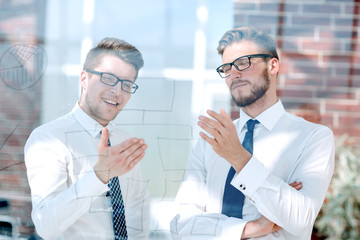 close up.two employees talking standing in the office