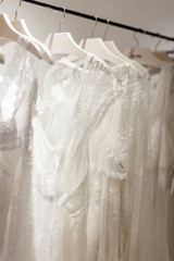 Close up view of stand with wedding gowns