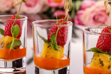 Strawberry with pineapple in hot sauce with greens