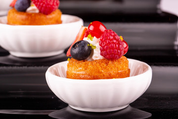 A biscuit with cream berry and fresh berries