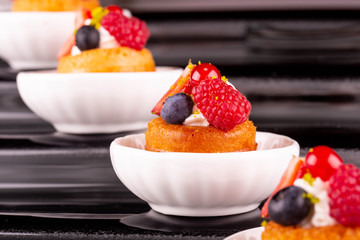 A peach biscuit with mousse, raspberry, blackberry and strawberry