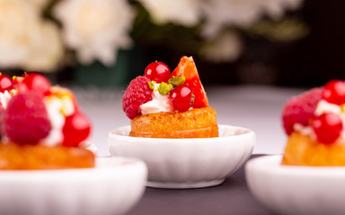 An orange dessert with red currant and raspberry