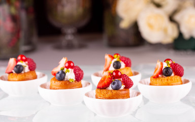 Bilberry, strawberry and raspberry on fresh pastries with mousse