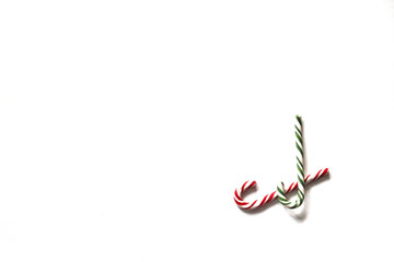 Two candy canes on white background