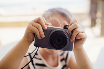 Kid taking a photo to camera