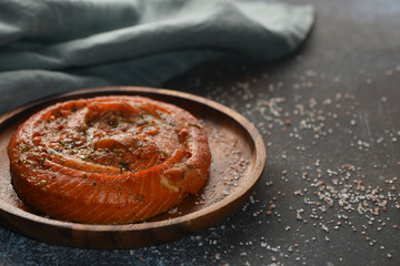 Smoked salmon roll on wood plate