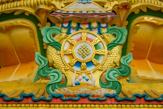 golden green image of Tibetan Buddhist shrines on the wall of the temple
