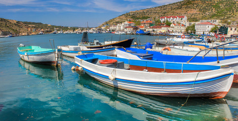 Fototapeta na wymiar Fishing boats in Balaclava with beautiful port, Peninsula of Crimea, Black Sea