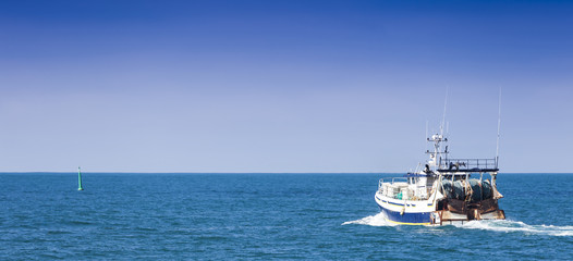Homecoming: Tired fishermans ship approaching after a hard day