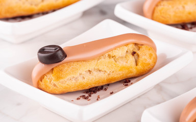 A coffee eclair with a chocolate crumb