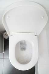 Toilet bowl top view in water closet.