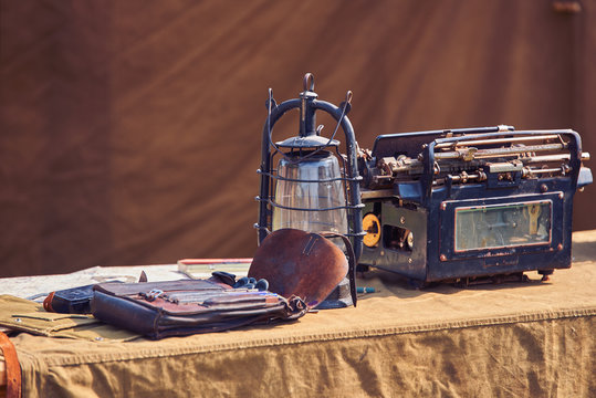 Vintage lantern and old typewriter on military table
