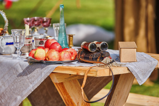 Still life of apples, glasses and old royal binoculars
