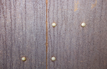 Rusty metal background with rivets for design