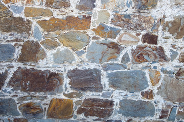 Old stone castle wall. Polygonal masonry. Rough stones stonewall